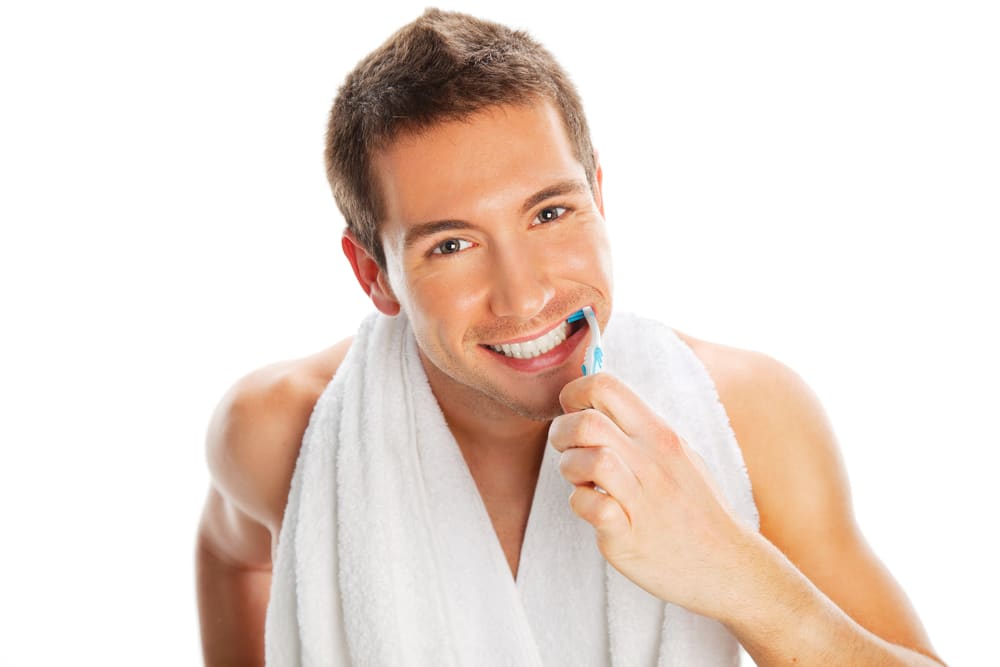 Man removing plaque for healthy gums in Herrin, IL