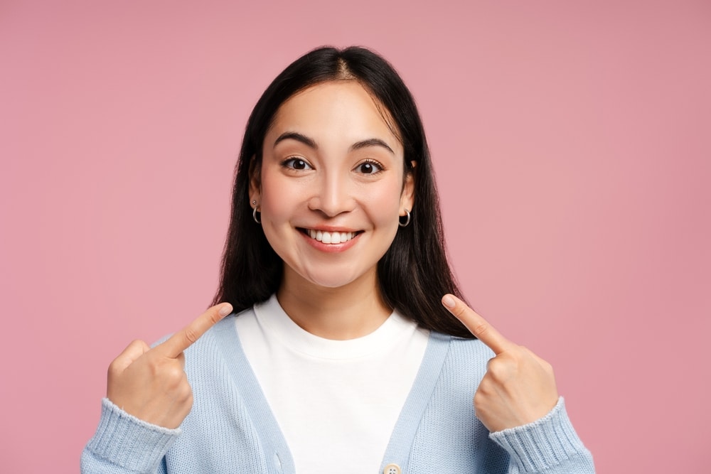 Woman with great smile after tooth replacement with implants in Herrin, IL